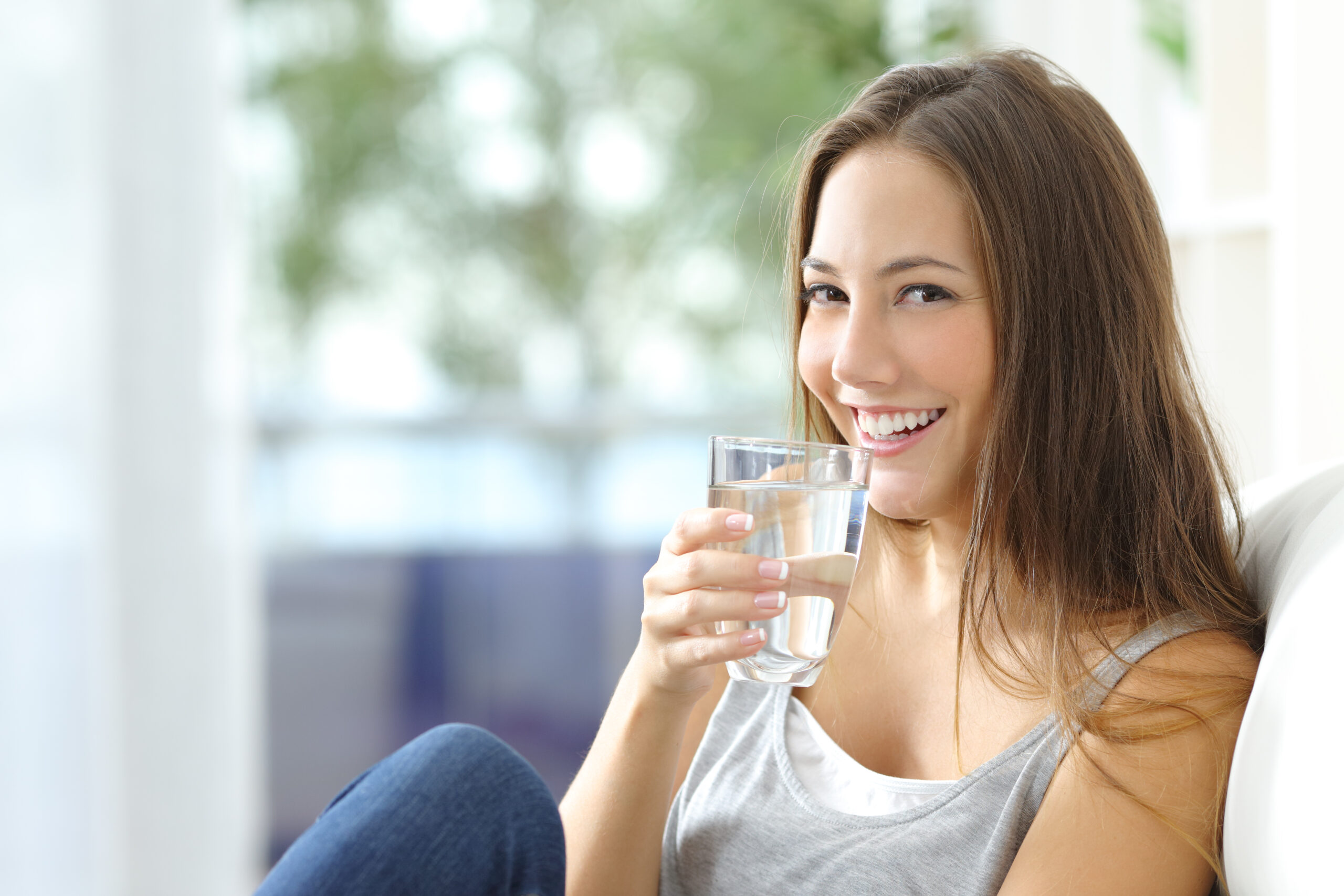 young woman drinking glass of water
